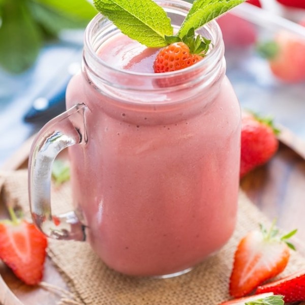 Healthy Strawberry Shake garnished with fresh strawberries and mint leaves
