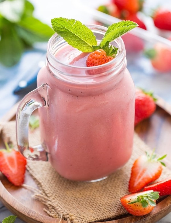 Healthy Strawberry Shake garnished with fresh strawberries and mint leaves