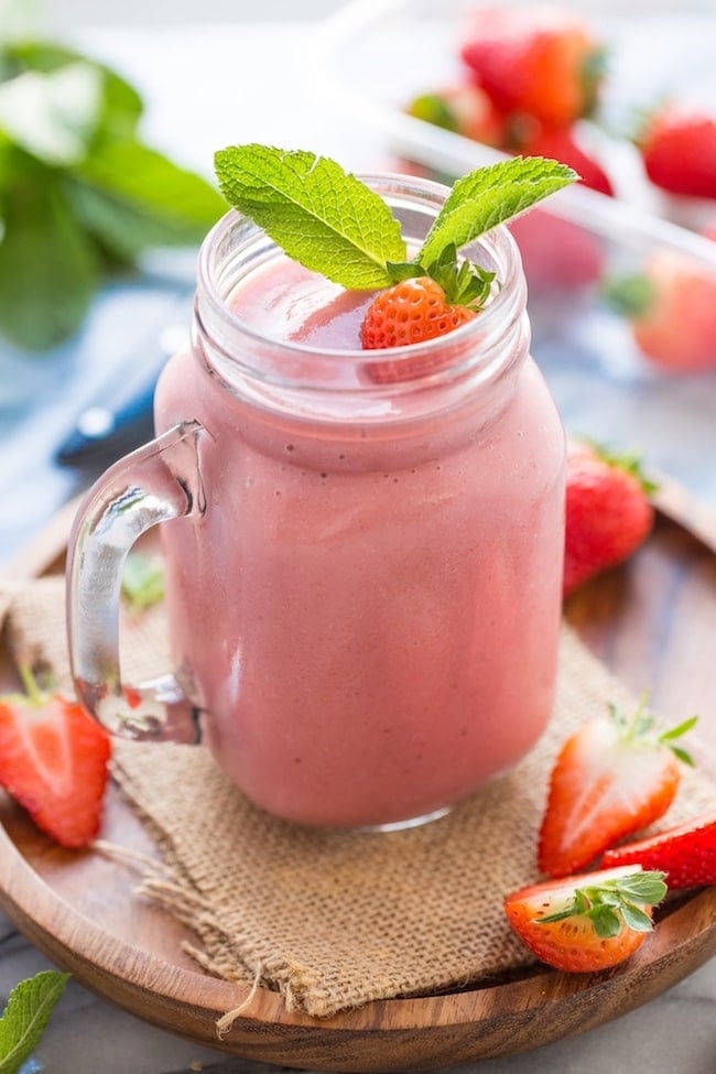 Healthy Strawberry Shake garnished with fresh strawberries and mint leaves