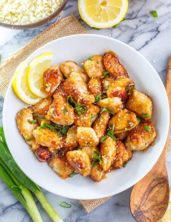 Paleo Chinese Lemon Chicken with lemon slices, sesame seeds and spring onions