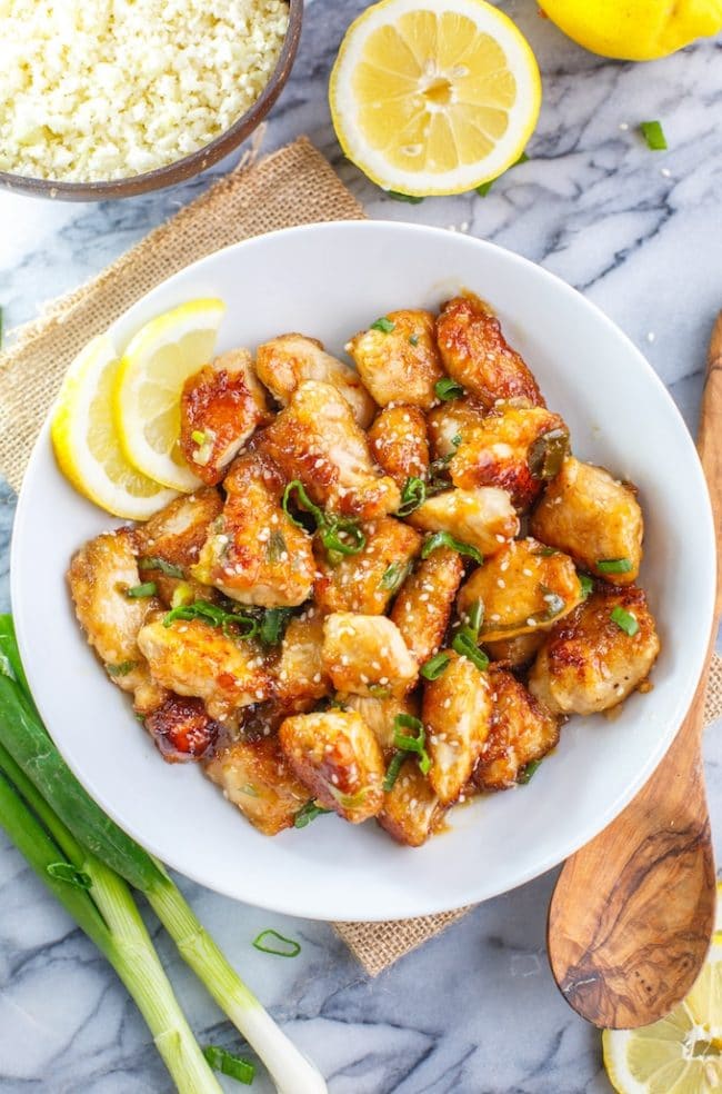 Paleo Chinese Lemon Chicken with lemon slices, sesame seeds and spring onions