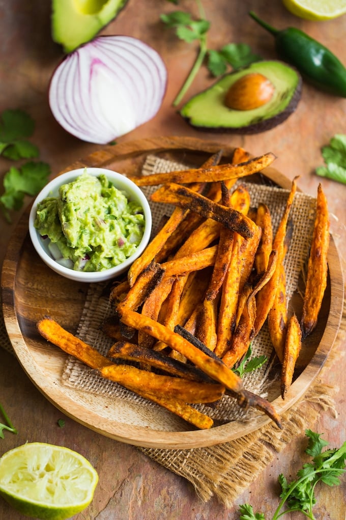 Crispy Baked Sweet Potato Fries on a plate with a side of guacamole 