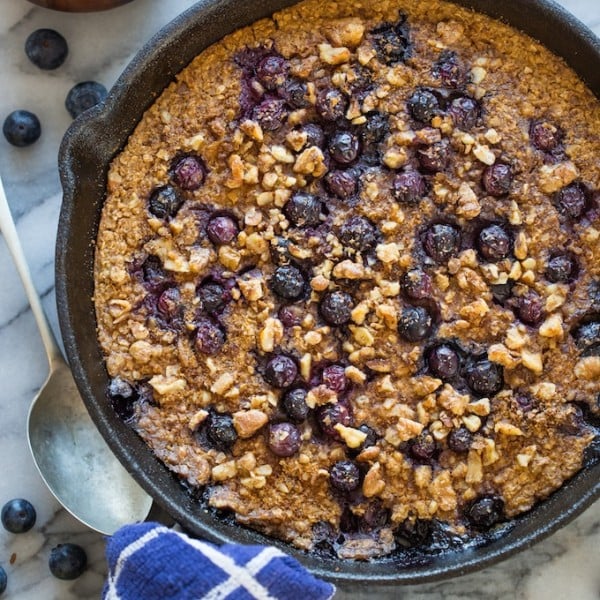 Blueberry Oatmeal Bake surrounded by flowers and blueberries