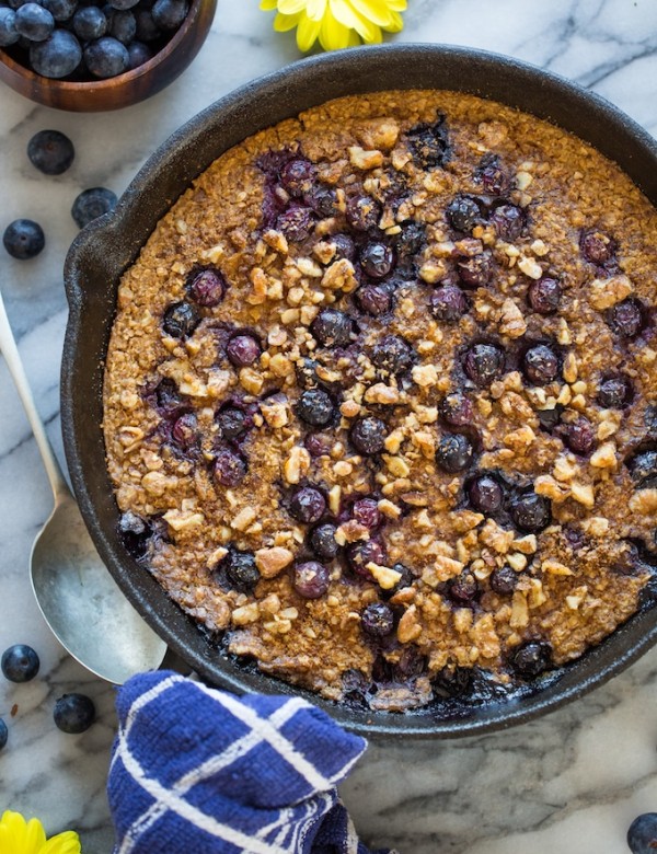 Blueberry Oatmeal Bake surrounded by flowers and blueberries