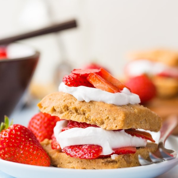 Gluten Free Vegan Strawberry Shortcake with coconut whipped cream and fresh berries presented on a plate