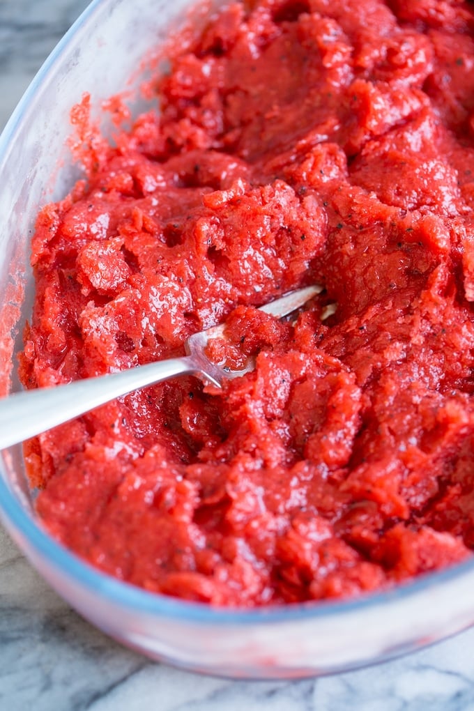 Strawberry Granita with Passion Fruit up close with a fork breaking it up