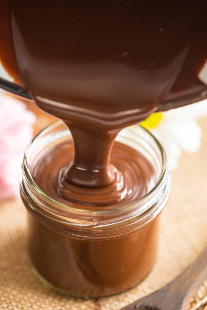 Dairy Free Hot Fudge poured into a small jar from a cooking pot