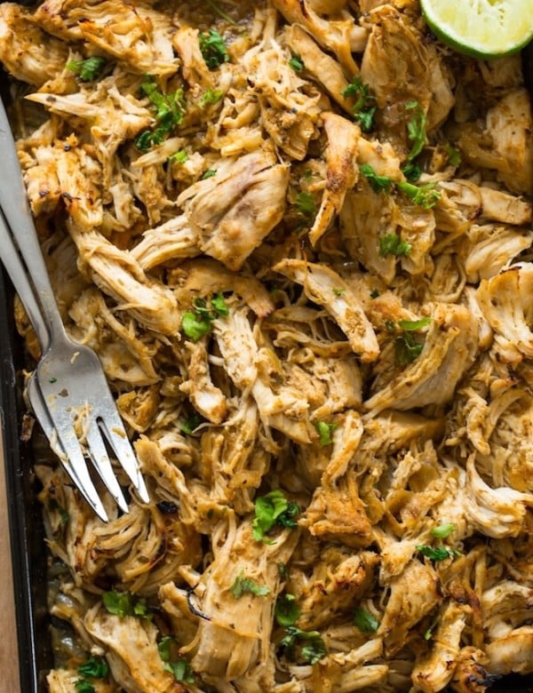 Instant Pot Chicken Carnitas shredded on a baking sheet with forks