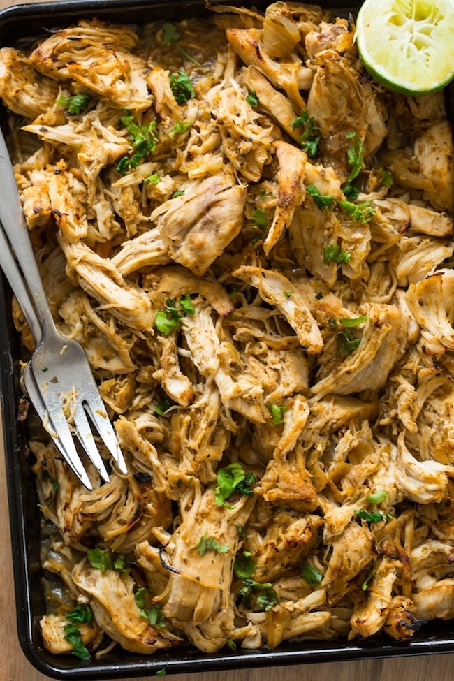 Instant Pot Chicken Carnitas shredded on a baking sheet with forks 