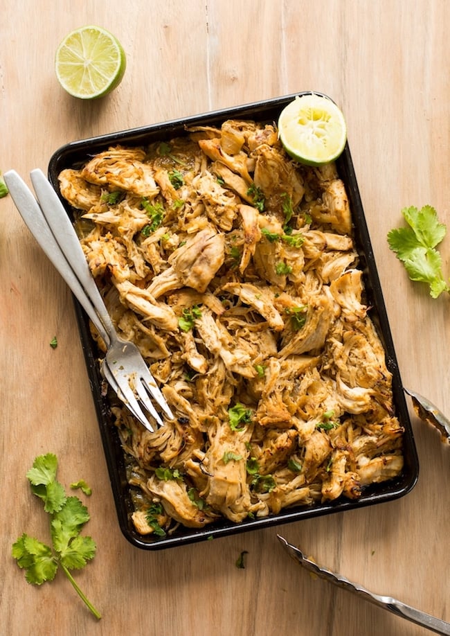 Instant Pot Chicken Carnitas shredded on a baking sheet with forks 