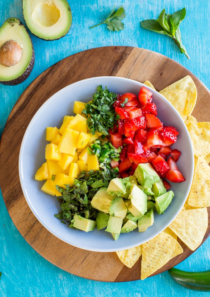 Avocado Strawberry Mango Salsa ingredients in a bowl before before mixed together