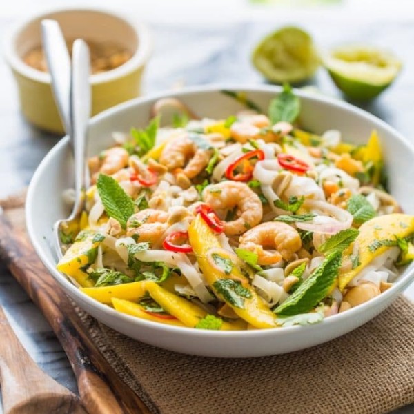 Spicy Mango & Shrimp Thai Noodle Salad tossed in a bowl with forks