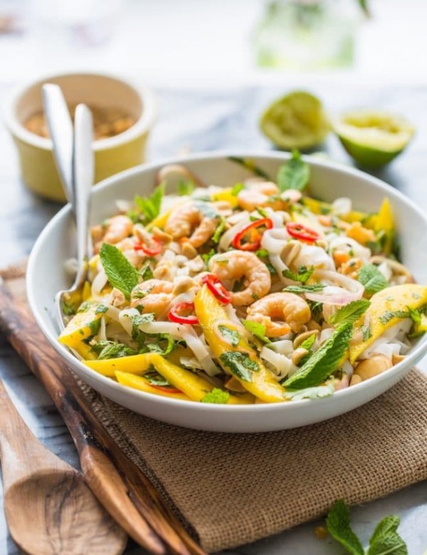 Spicy Mango & Shrimp Thai Noodle Salad tossed in a bowl with forks