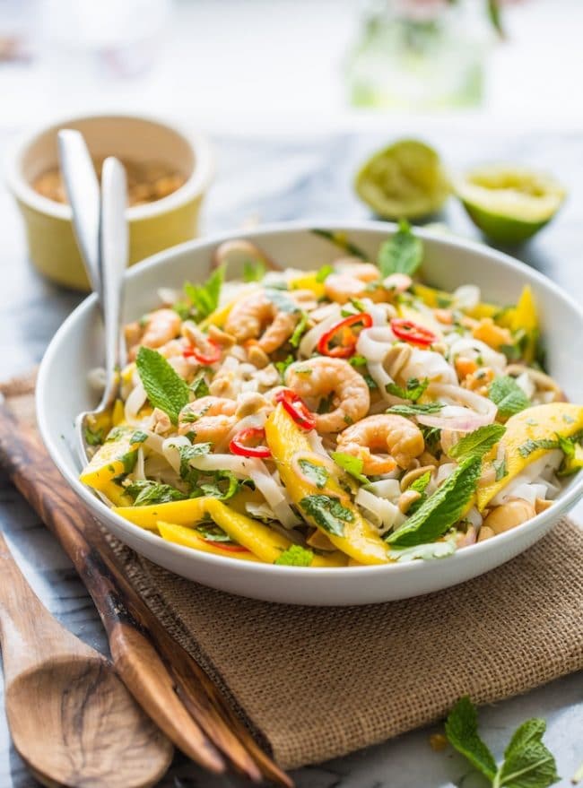 Spicy Mango & Shrimp Thai Noodle Salad tossed in a bowl with forks