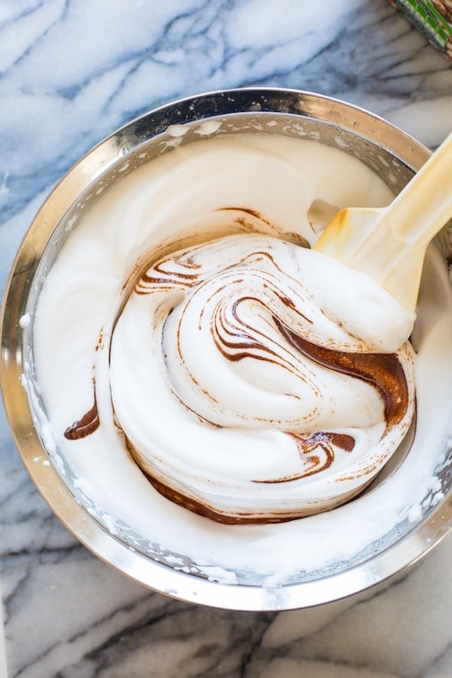 making of Aquafaba Chocolate Mousse: picture of aquafaba fluffed up with melted chocolate swirled in 