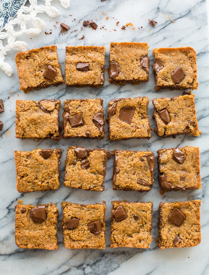 Paleo Almond Butter vegan Blondies cut into squares on a marble counter