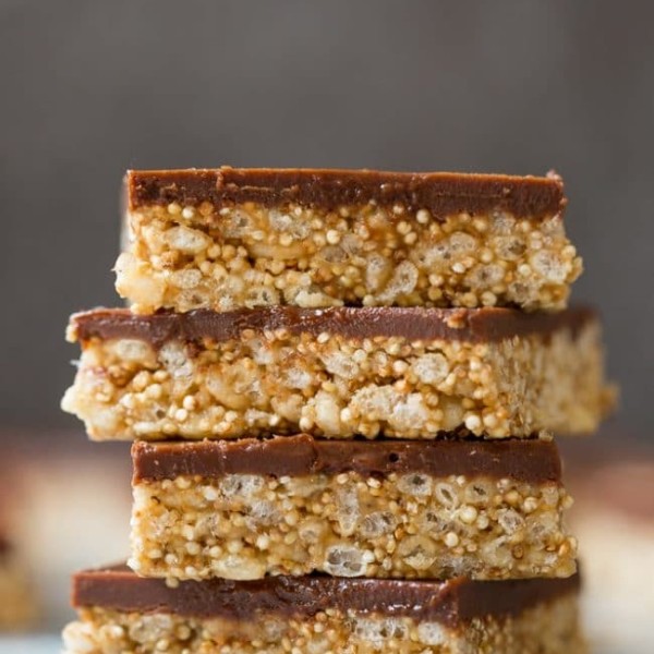 4 Toasted Quinoa Peanut Butter Scotcharoos stacked on top of each other