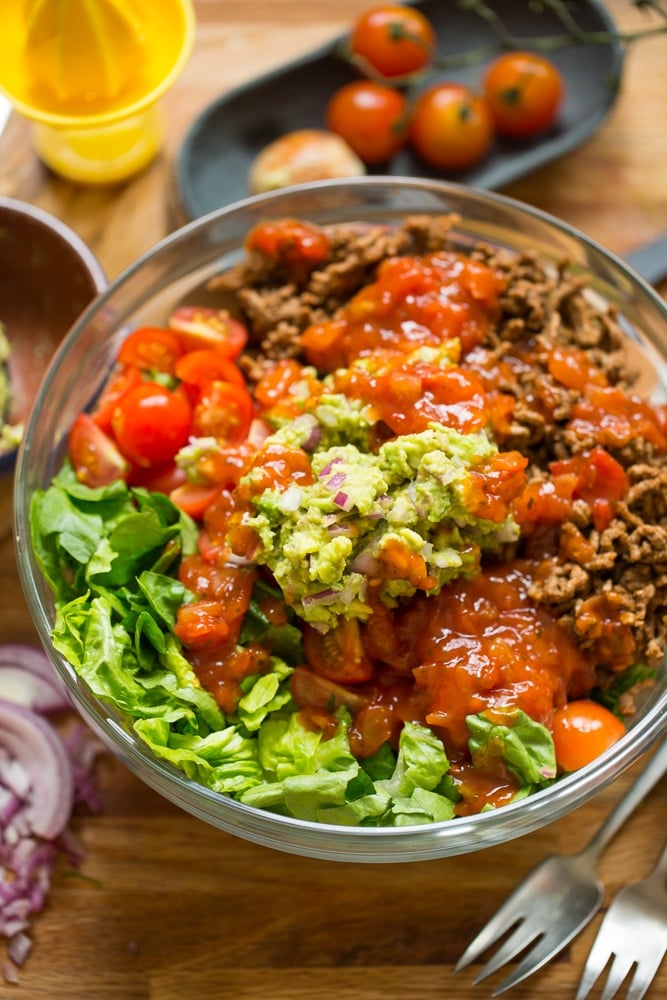 Whole30 Taco Salad in a bowl topped with salsa and guacamole