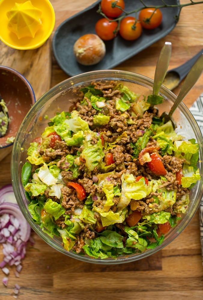 Whole30 Taco Salad mixed in a bowl topped with salsa and guacamole