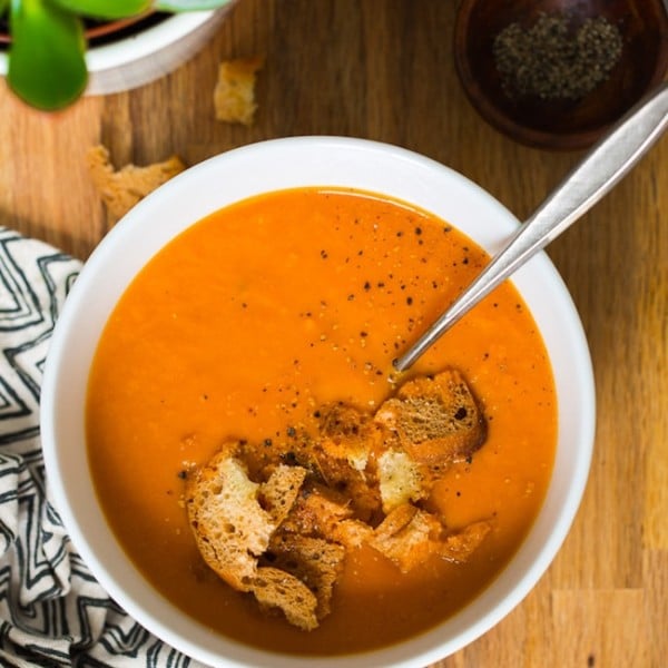 Instant Pot Tomato Soup in a bowl topped with croutons and black pepper