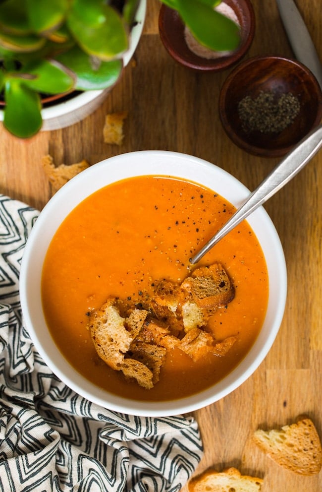 Instant Pot Tomato Soup in a bowl topped with croutons and black pepper
