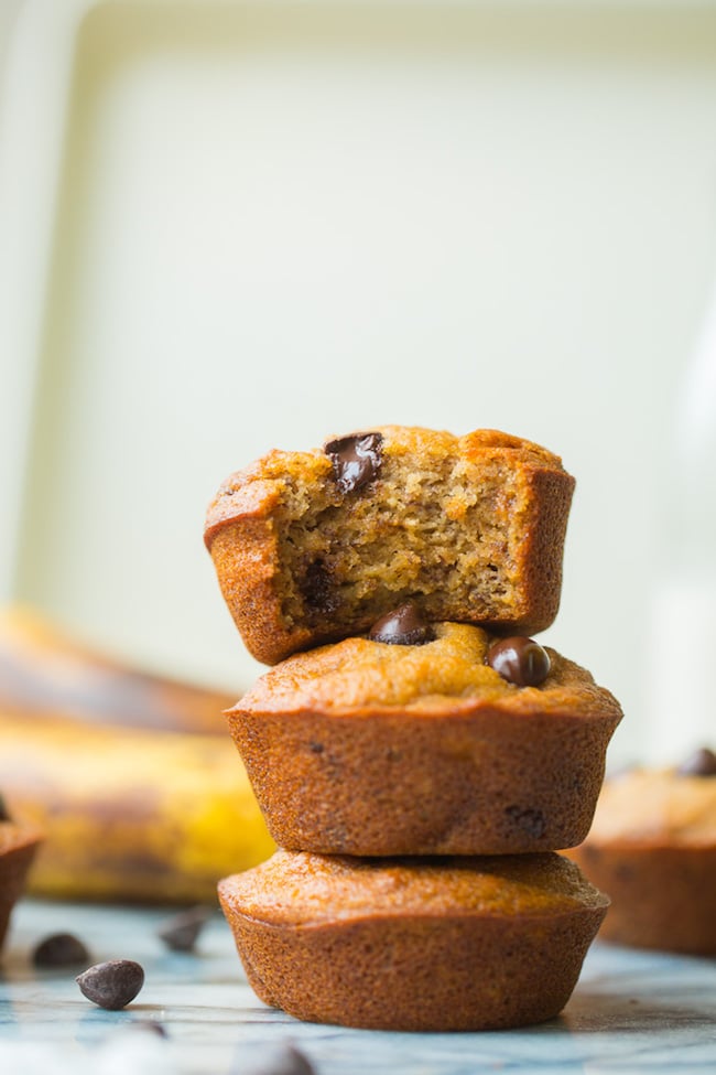 Paleo Banana Muffins stacked with a bite taken out of the top