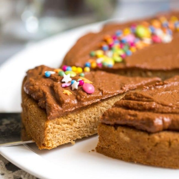 slice of Vegan Coconut Flour Cake frosted with chocolate frosting