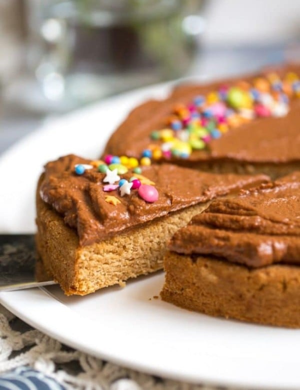 slice of Vegan Coconut Flour Cake frosted with chocolate frosting