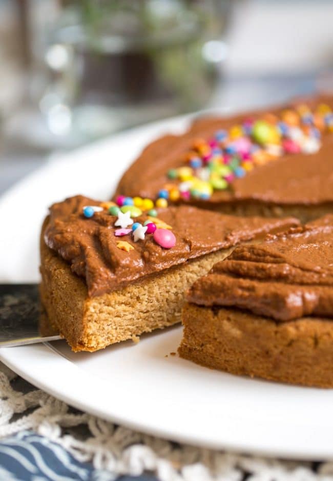 slice of Vegan Coconut Flour Cake frosted with chocolate frosting