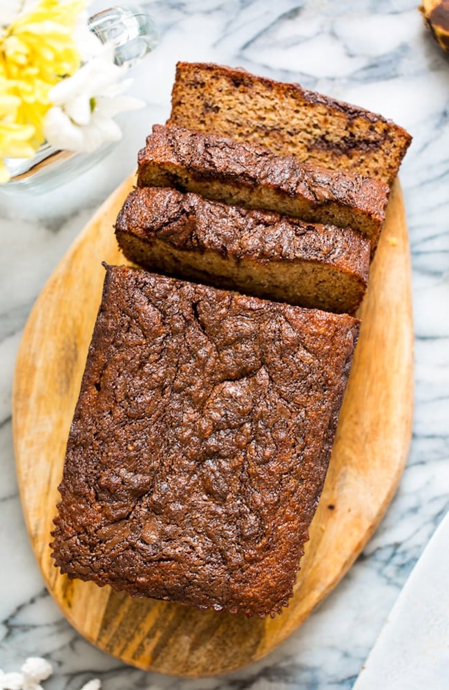 paleo banana bread on a cutting board with slices