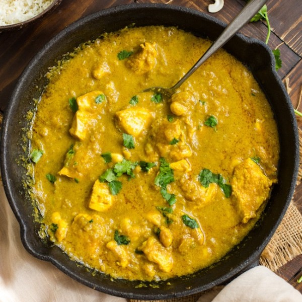 Chicken Korma with Coconut Milk in a cast iron skillet and topped with cilantro