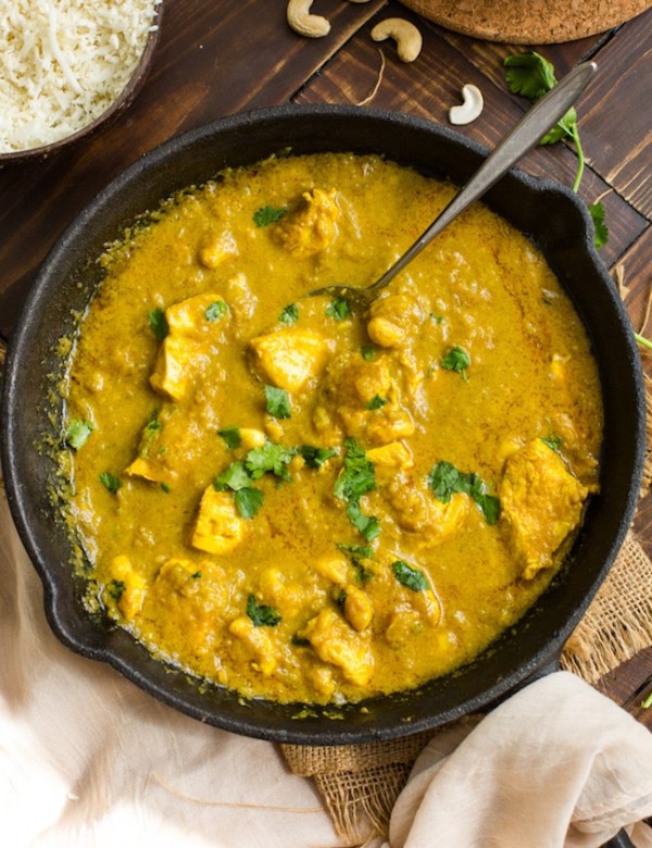 Chicken Korma with Coconut Milk in a cast iron skillet and topped with cilantro