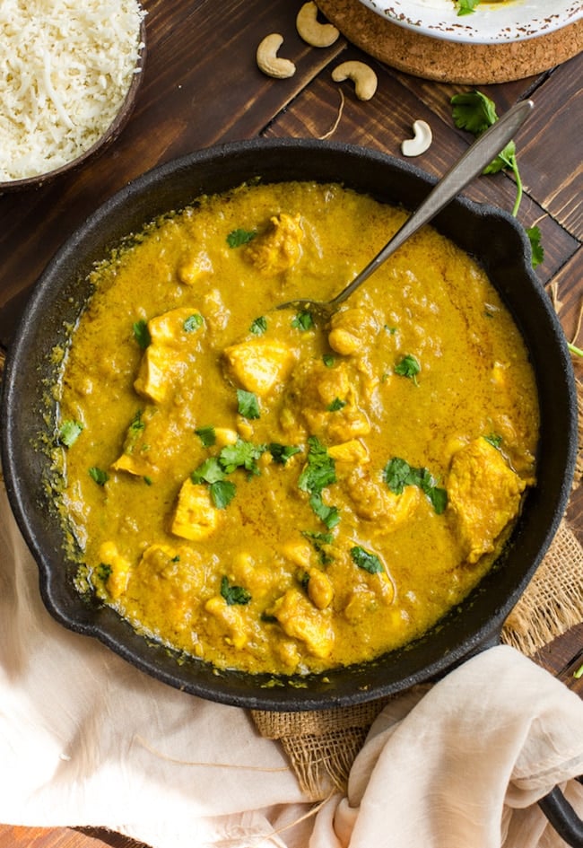 Chicken Korma with Coconut Milk in a cast iron skillet and topped with cilantro