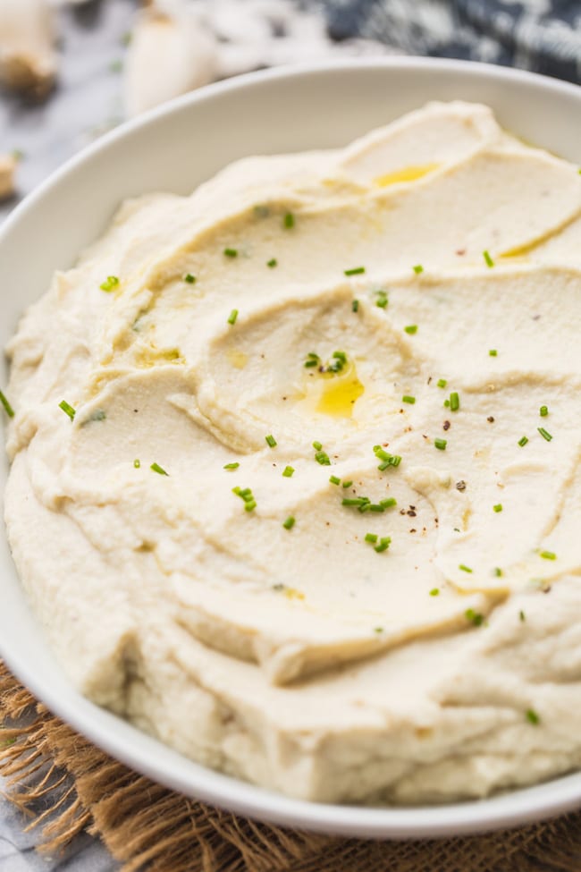 Creamy Mashed Cauliflower topped with melted butter and fresh chives
