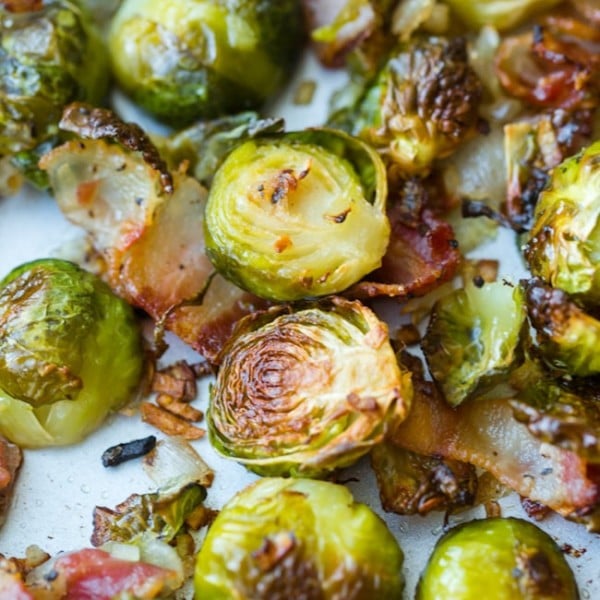 Crispy Roasted Brussels Sprouts with Bacon & Shallots on a baking sheet