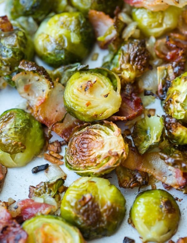 Crispy Roasted Brussels Sprouts with Bacon & Shallots on a baking sheet