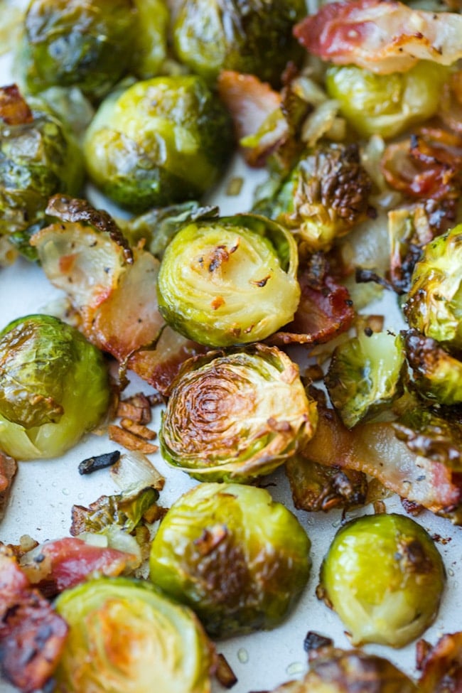 Crispy Roasted Brussels Sprouts with Bacon & Shallots on a baking sheet