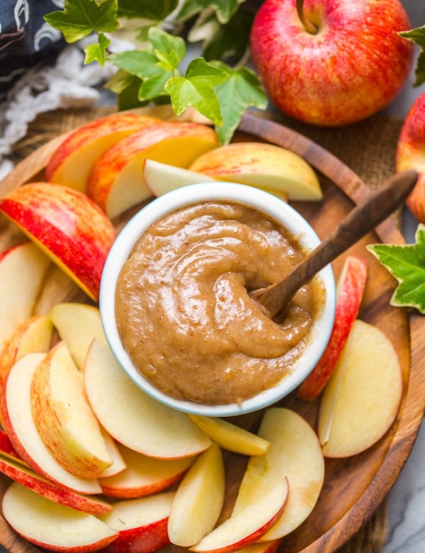 up close look at vegan date caramel on a plate with sliced apples