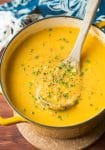 vegan corn chowder in a soup pot with a ladle