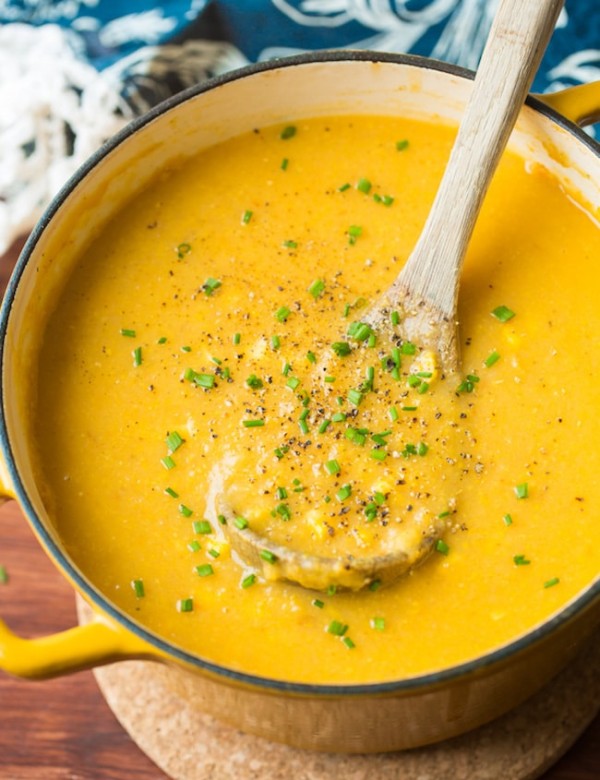 vegan corn chowder in a soup pot with a ladle