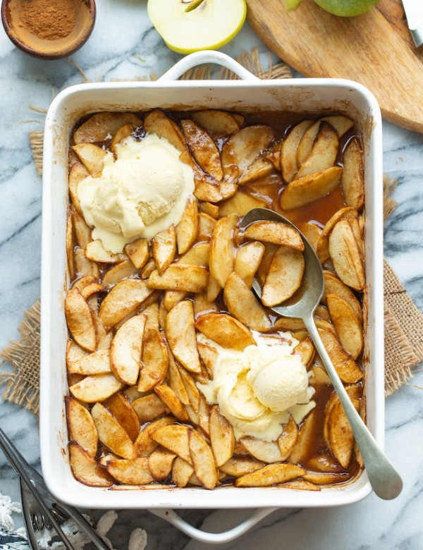 Baked Cinnamon Apples in a baking dish topped with ice cream