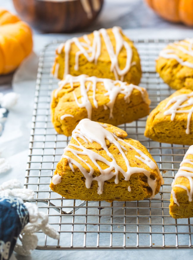 Gluten Free Vegan Pumpkin Scones drizzled with a maple dressing on a cooling rack