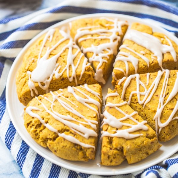 Gluten Free Vegan Pumpkin Scones on a plate on a blue and white striped kitchen towel