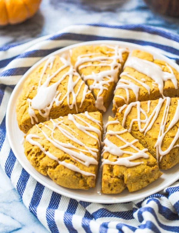 Gluten Free Vegan Pumpkin Scones on a plate on a blue and white striped kitchen towel