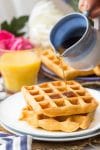 Gluten Free Waffles on a plate with maple syrup pouring over the top
