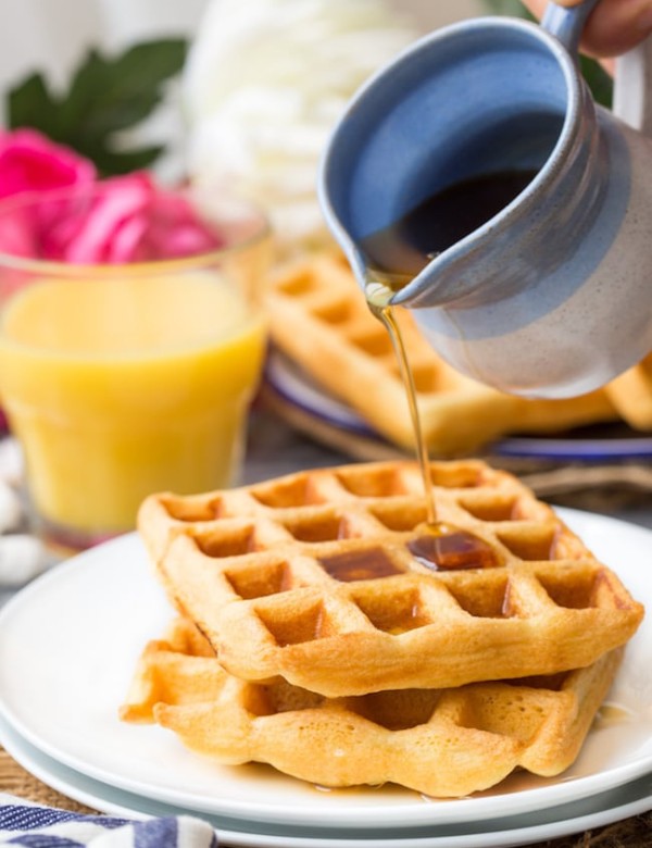 Gluten Free Waffles on a plate with maple syrup pouring over the top