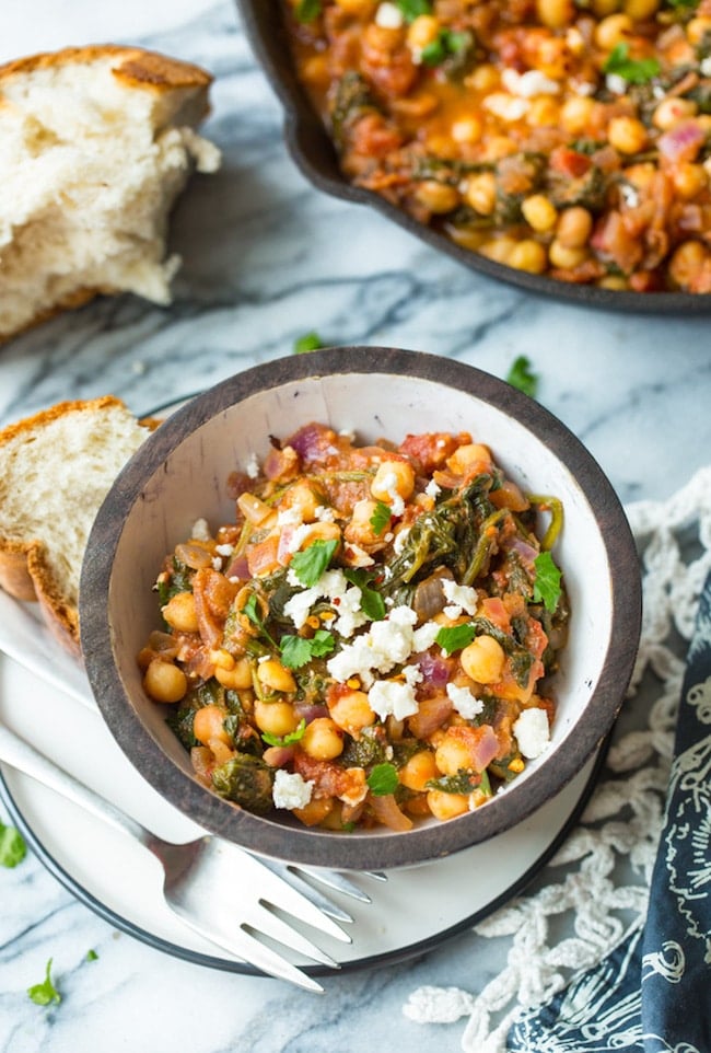 Mediterranean Chickpea Stew with Spinach & Feta in a bowl with a side of bread