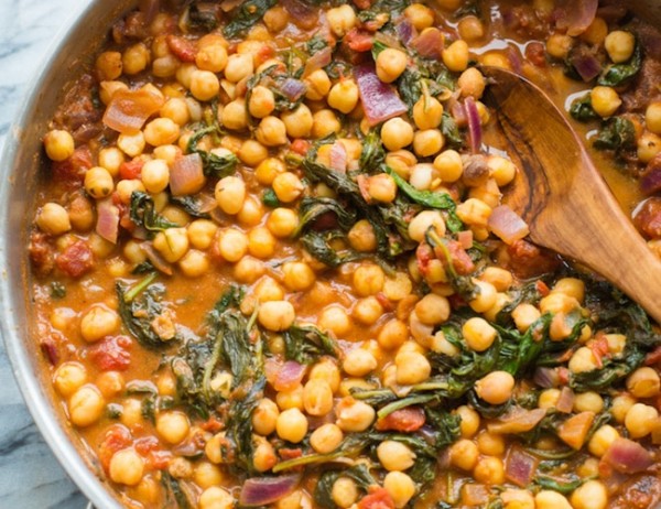 Mediterranean Chickpea Stew with Spinach & Feta in a cooking skillet