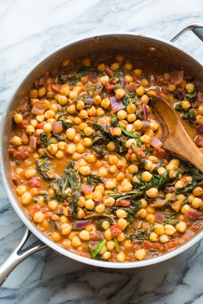 Mediterranean Chickpea Stew with Spinach & Feta in a cooking skillet