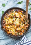 Stove Top Sweet Potato & Black Bean Enchilada Casserole in a skillet topped with cilantro